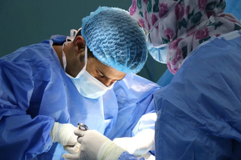 Group of doctors performing surgery