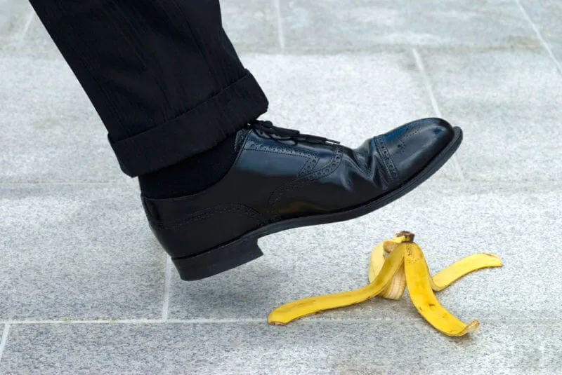 black show stepping on a banana peel