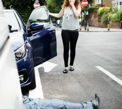 woman talking on the phone during accident with man on the floor