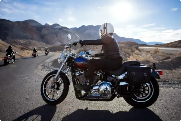 group of bikers riding along empty road