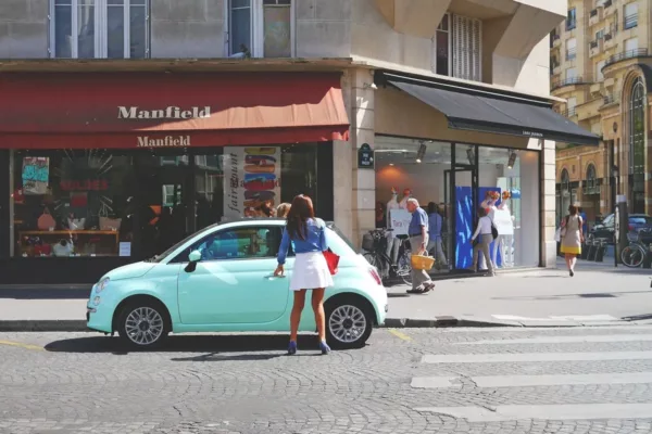 pedestrian getting inside small green car
